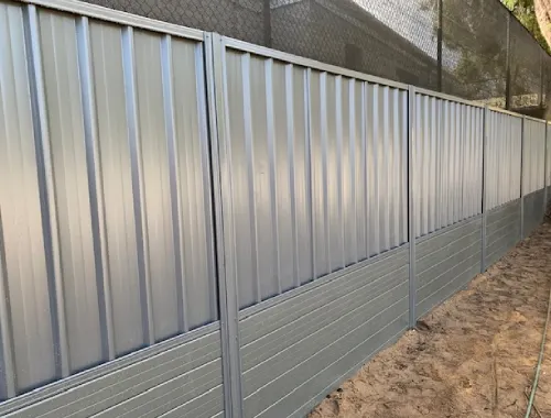 Colorbond boundary fence installed with steel sleeper support