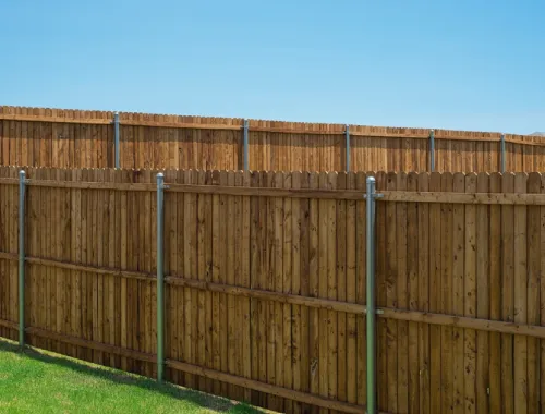 Tall timber fencing installed around a residential pool area for privacy