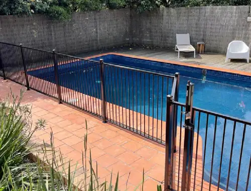 Residential pool fencing installed around an outdoor backyard area