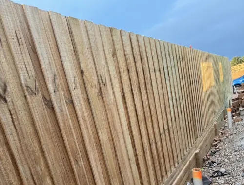 Timber fence with retaining wall installed as one complete residential boundary solution