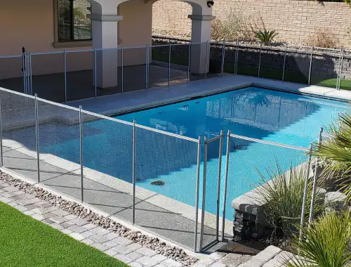 Steel blade pool fence installed around a residential outdoor area