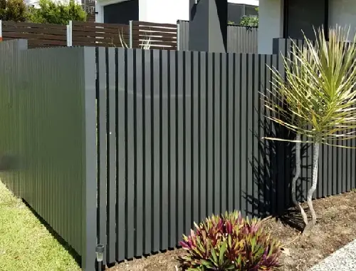 Vertical slat fence installed along a residential boundary