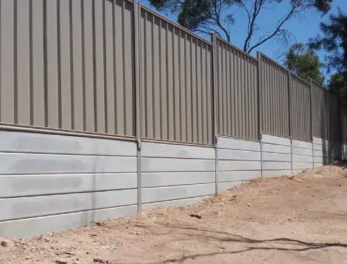 Colorbond fence built with sleeper base for residential boundary support