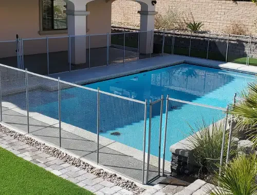 Steel blade pool fence installed around a residential outdoor area