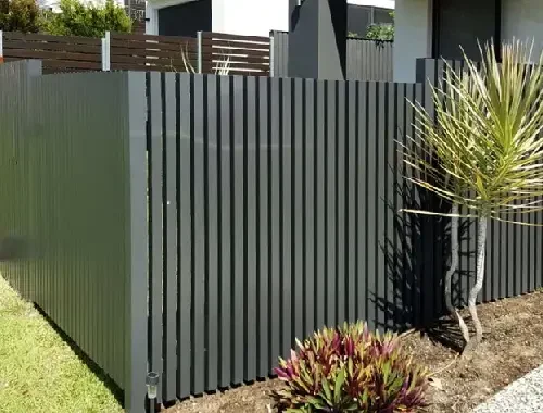 Vertical slat fence installed along a residential boundary